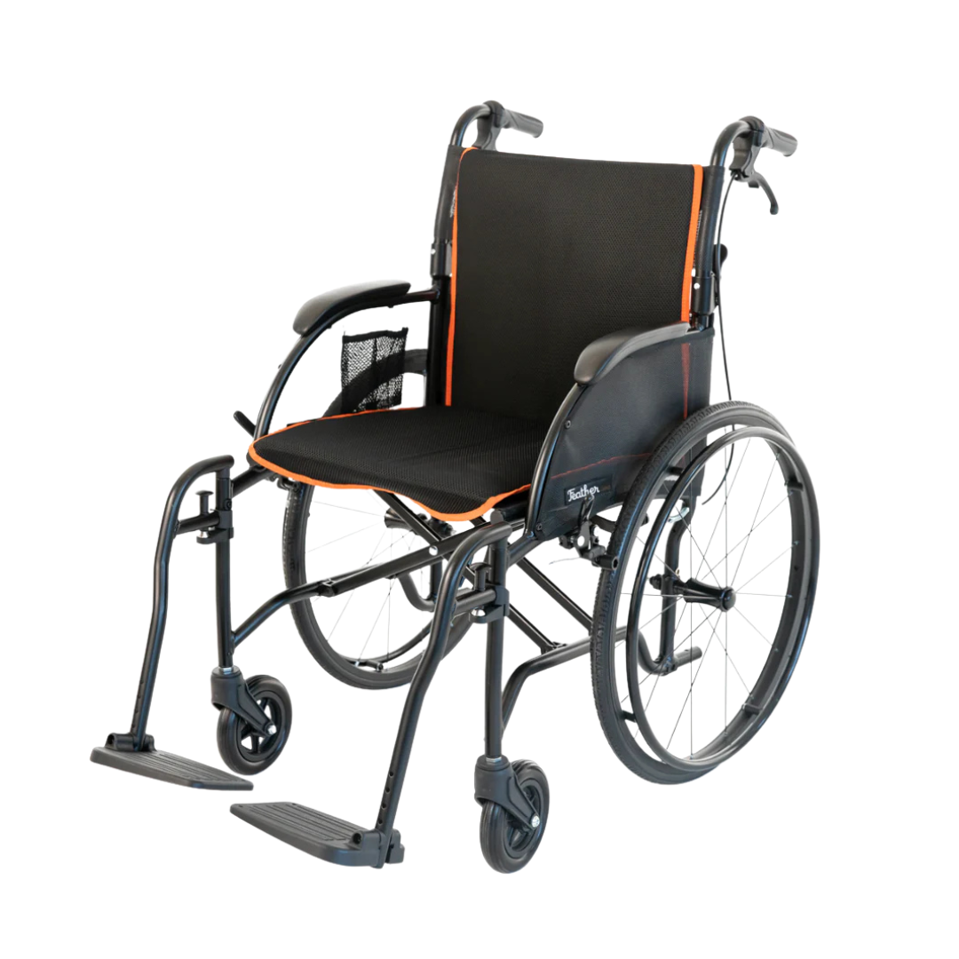 The Feather Chair 13.5 lb Lightweight Wheelchair, shown from a front-side angle against a white background, features black and orange accents, large quick-release rear wheels, small front wheels, footrests, armrests, and a side mesh storage pocket.